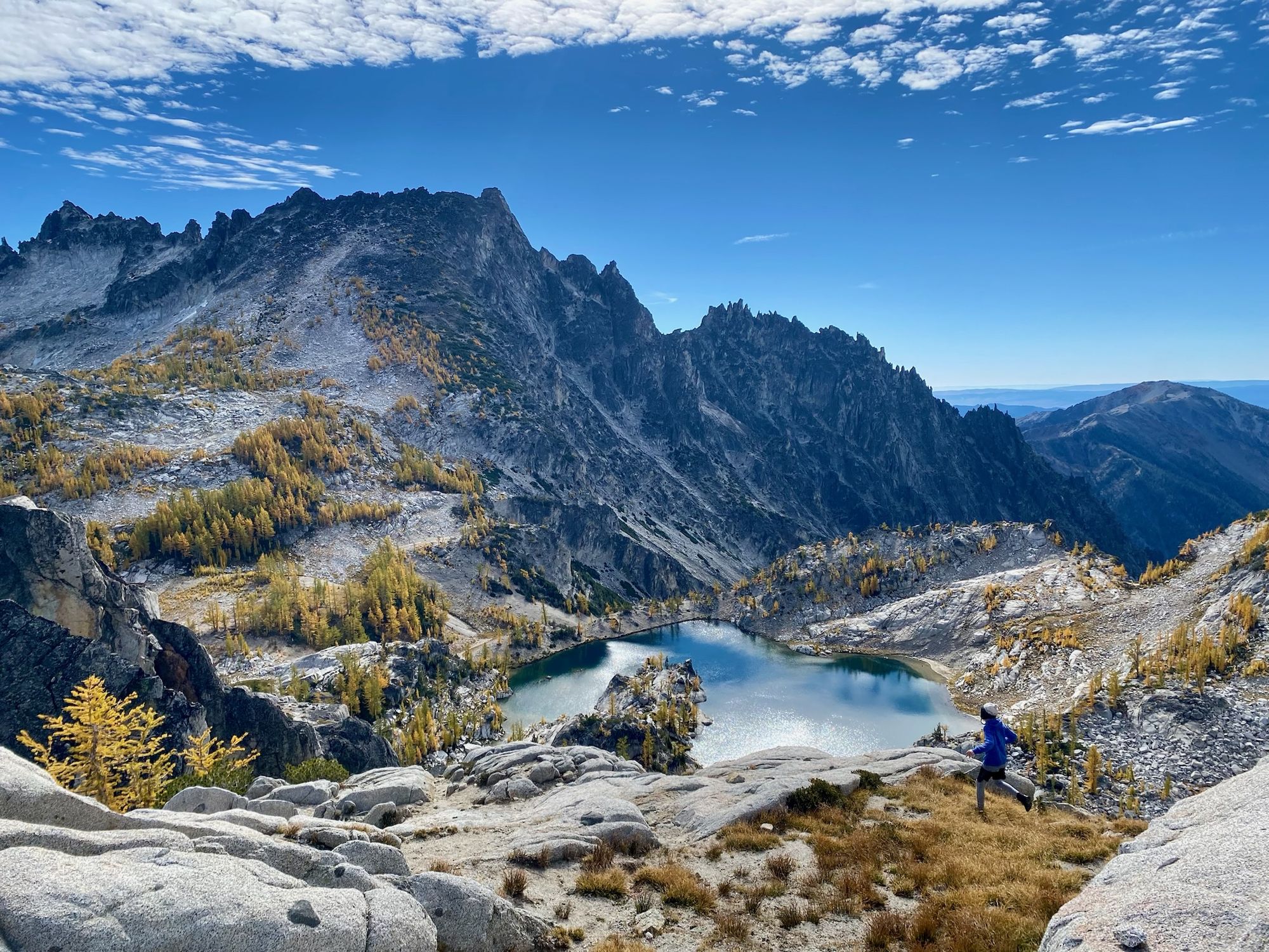 Runner cresting a ridge above an alpine lake near Bellingham, WA